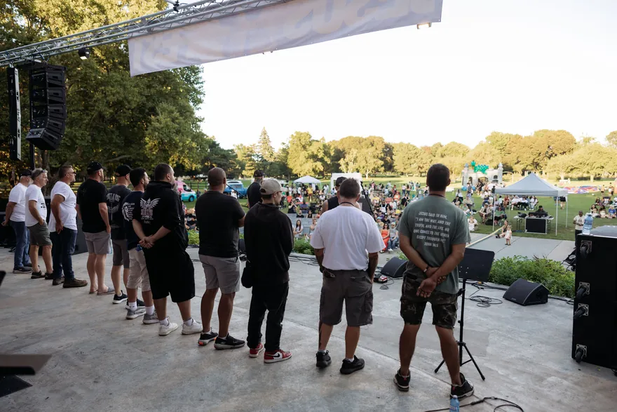 The Jesus Festival grounds, with a line of men standing in front of the main stage.